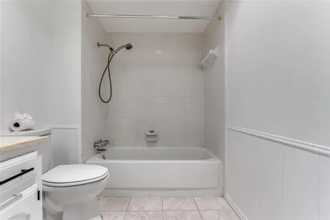 a bathroom with a toilet sink and shower