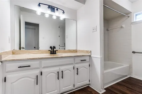 a bathroom with a bathtub and a sink