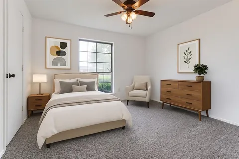 a spacious bedroom with a bed and a cabinets