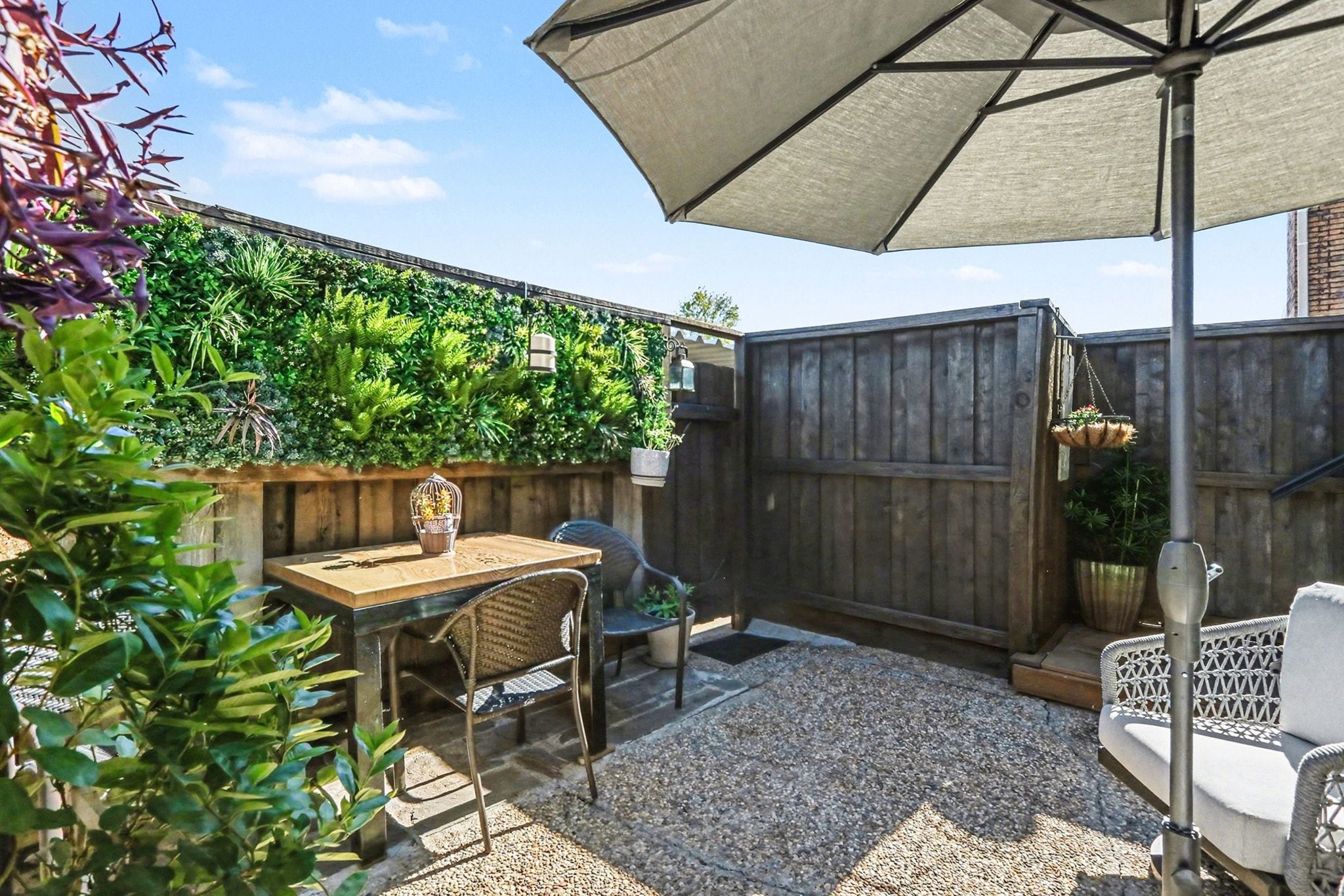 9407 Fondren Road Houston, TX 77074 - Photo 21 of 30 a patio with table and chairs and potted plants