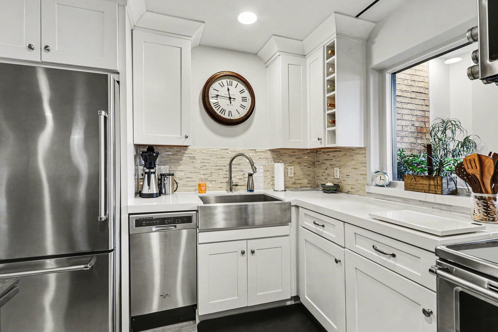 9407 Fondren Road Houston, TX 77074 - Photo 7 of 30 a kitchen with stainless steel appliances a refrigerator sink and cabinets