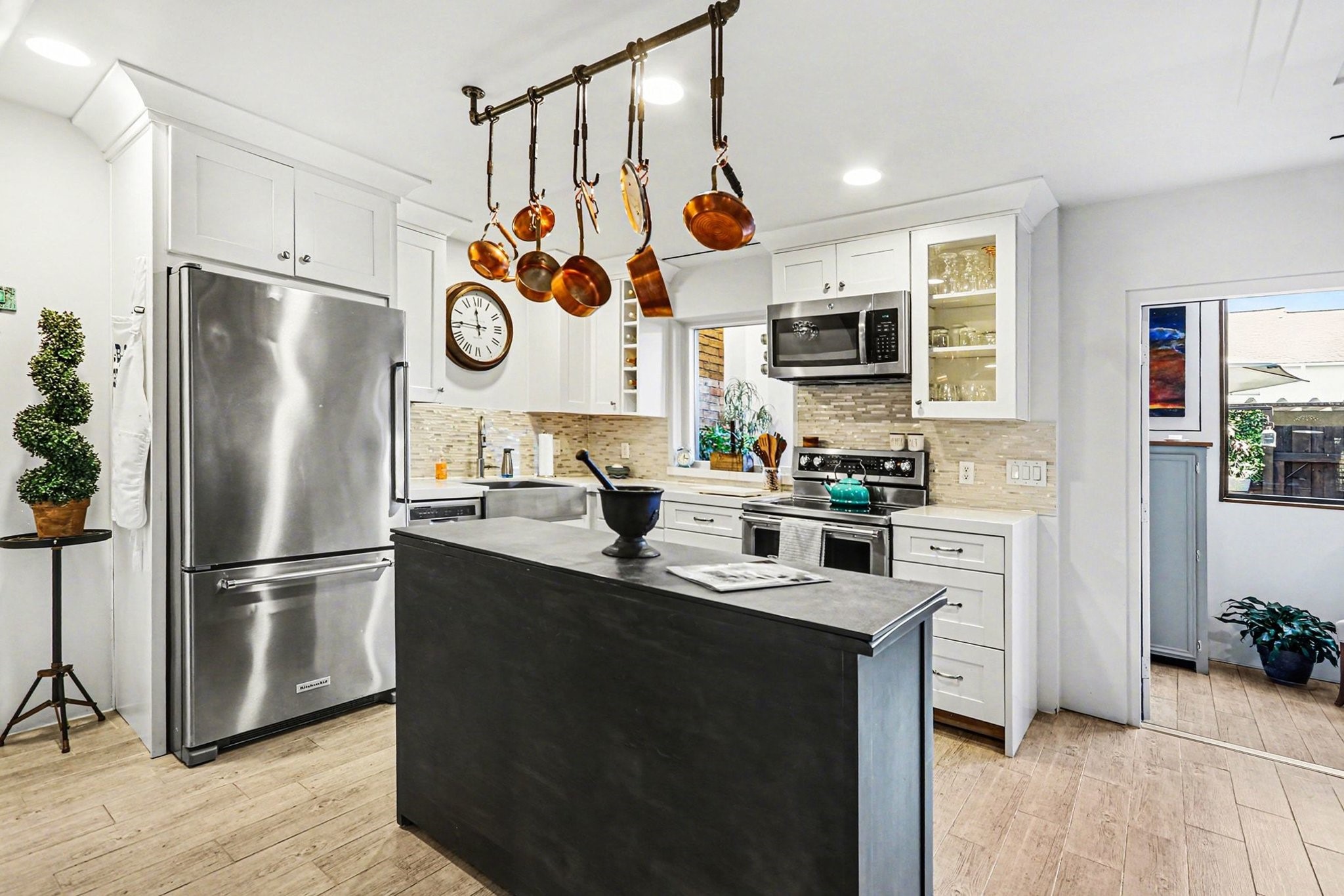 9407 Fondren Road Houston, TX 77074 - Photo 8 of 30 a kitchen with stainless steel appliances granite countertop a refrigerator a stove a sink and white cabinets with wooden floor