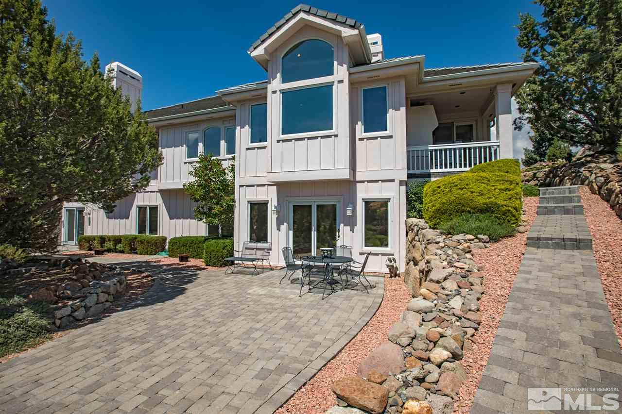 80 Promontory Pointe Reno, NV 89519 - Photo 23 of 25 a view of a brick house with large windows and a table and chairs