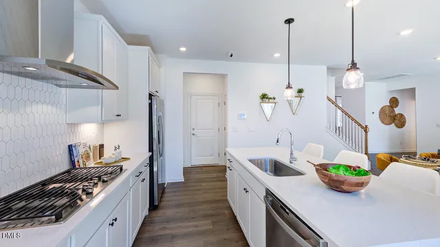 a living room with furniture kitchen view and a flat screen tv