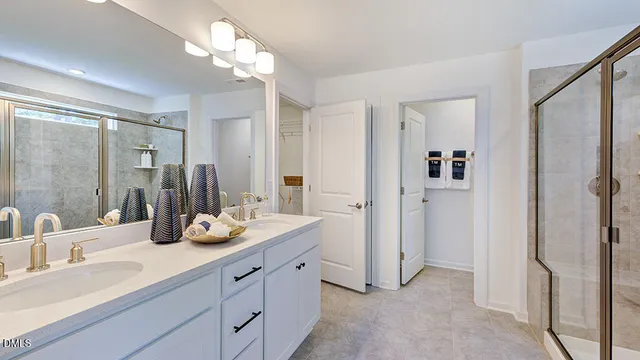 a bathroom with double vanity sink and a bathtub