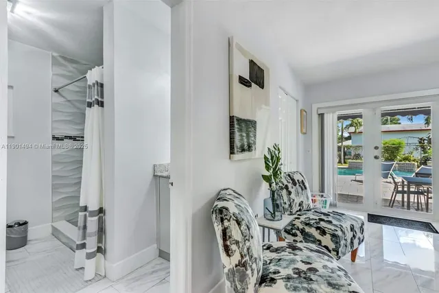 a view of a livingroom with furniture and floor to ceiling window
