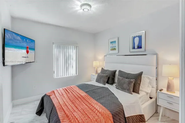 a bedroom with a bed and a painting on the wall