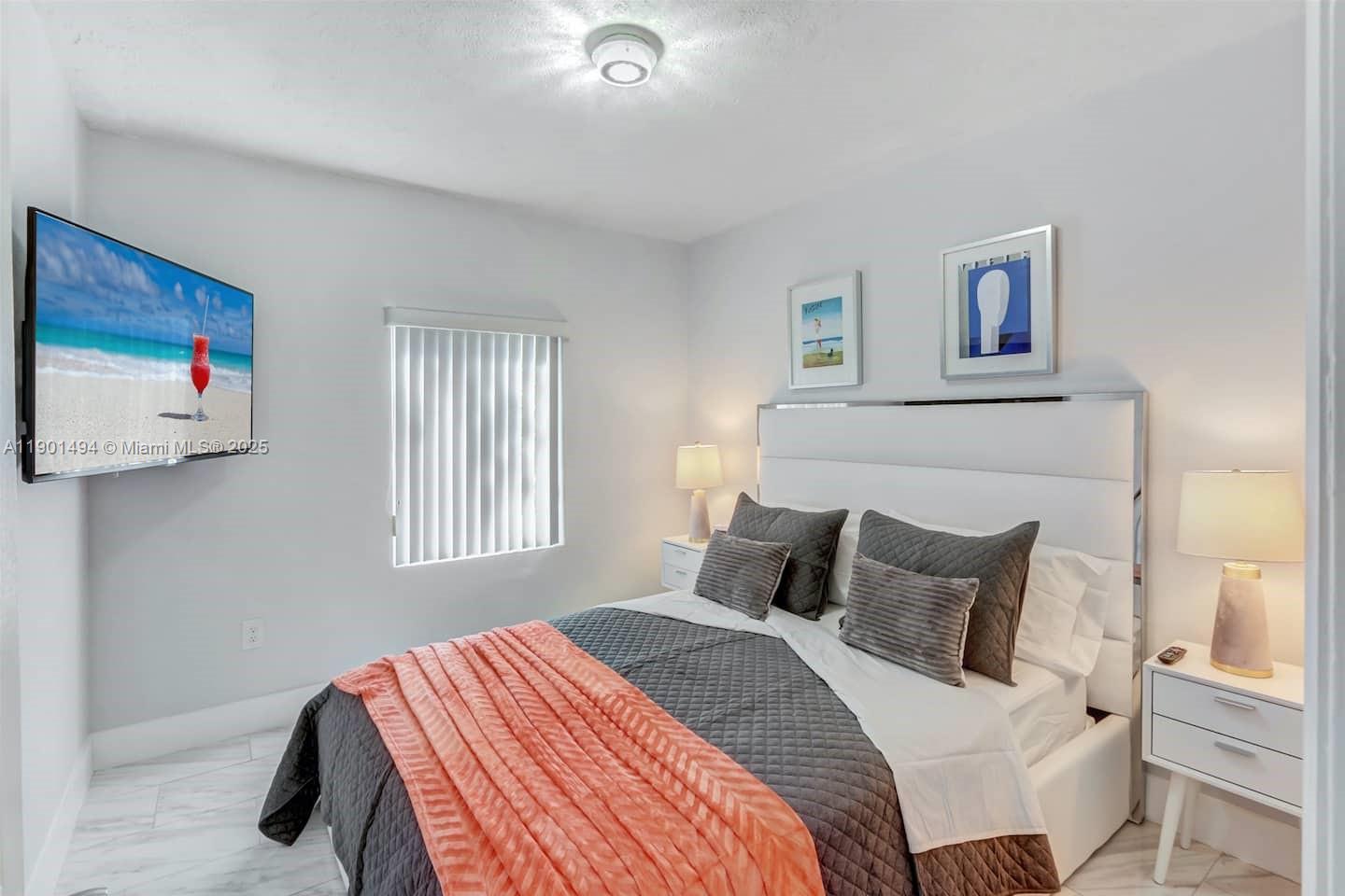 211 Southwest 4 Avenue Hallandale Beach, FL 33009 - Photo 16 of 25 a bedroom with a bed and a painting on the wall