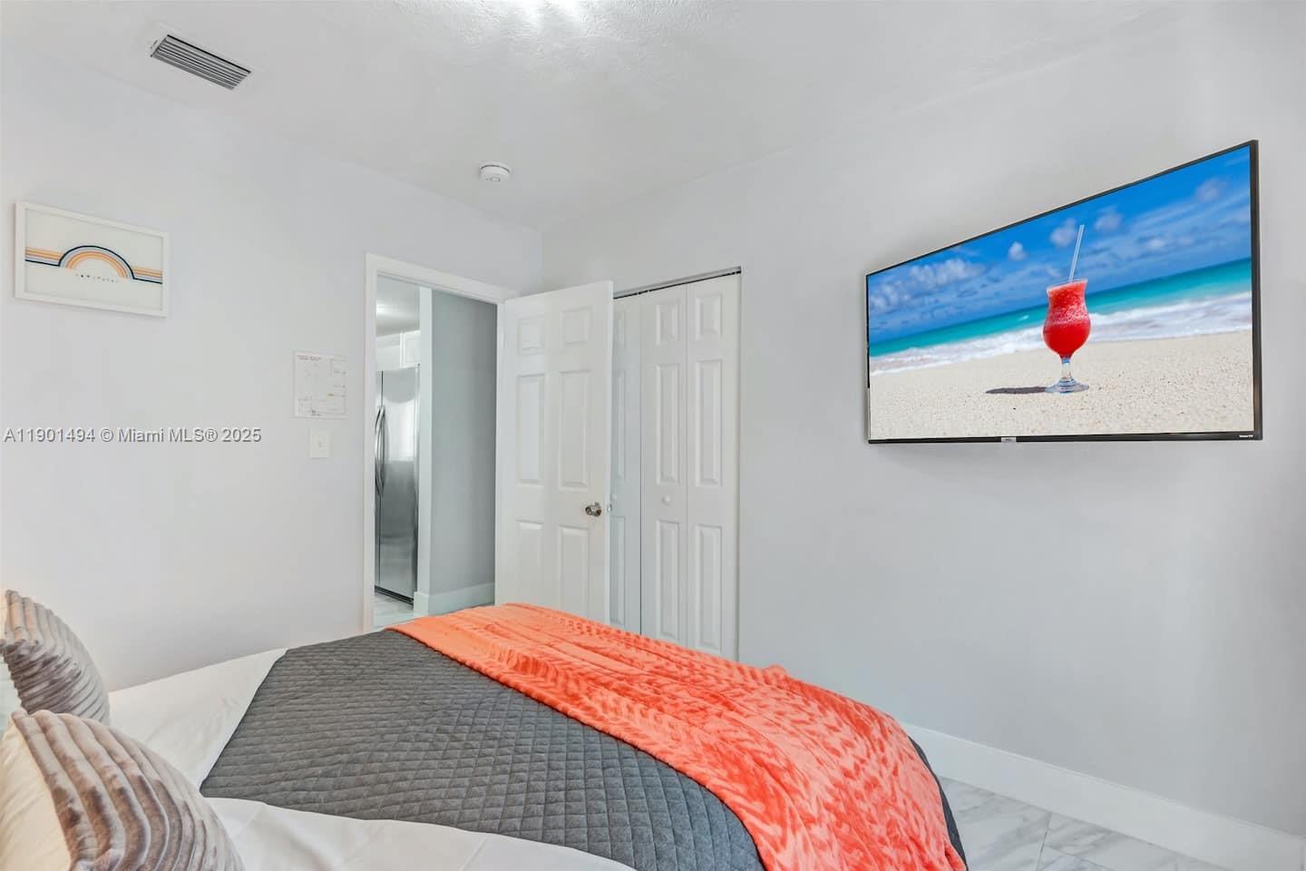 211 Southwest 4 Avenue Hallandale Beach, FL 33009 - Photo 17 of 25 a bedroom with a bed and painting on the wall