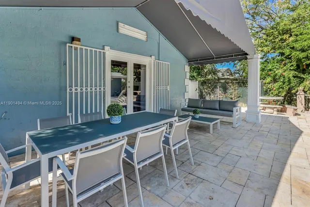 a dining room with furniture and a garden