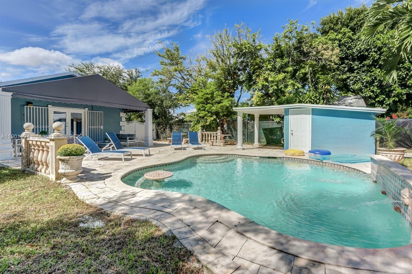211 Southwest 4 Avenue Hallandale Beach, FL 33009 - Photo 23 of 25 a swimming pool with outdoor seating and yard