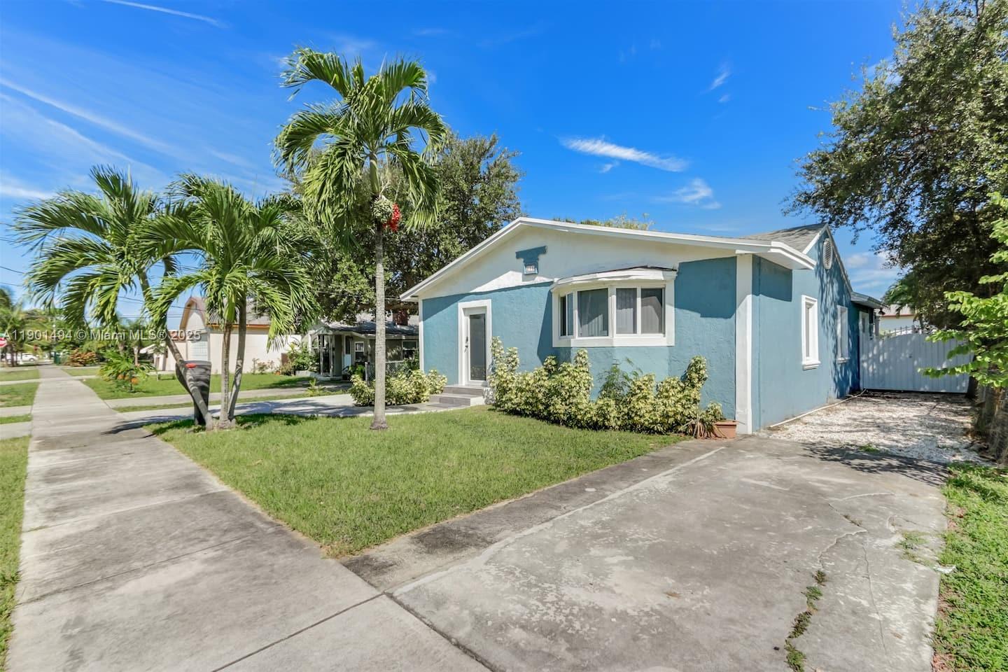 211 Southwest 4 Avenue Hallandale Beach, FL 33009 - Photo 25 of 25 a front view of a house with a garden and porch