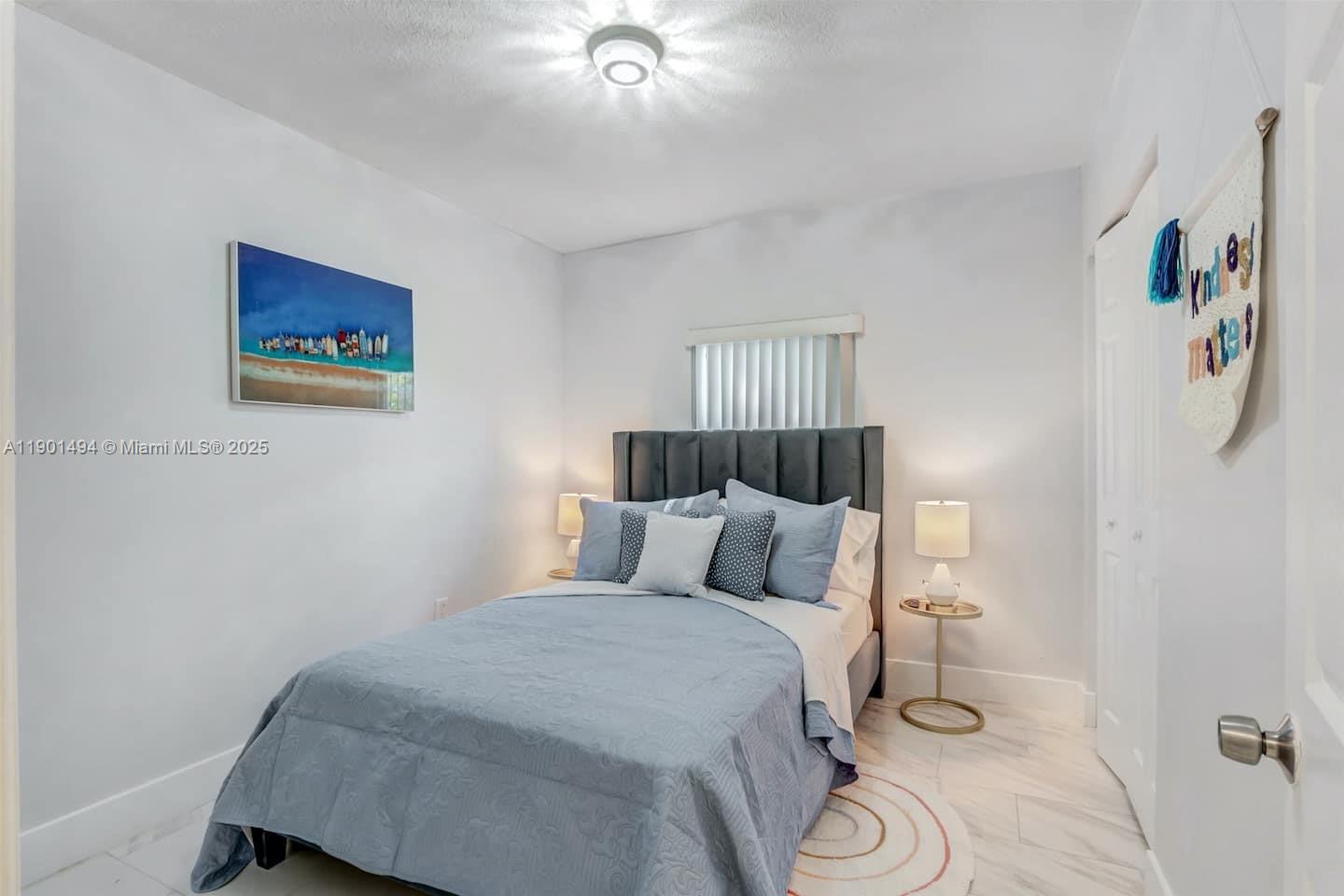 211 Southwest 4 Avenue Hallandale Beach, FL 33009 - Photo 7 of 25 a bedroom with a bed and a painting on the wall