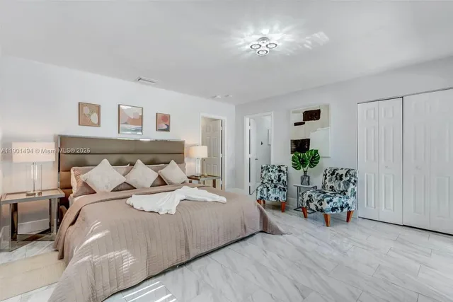 a bedroom with a bed and potted plant