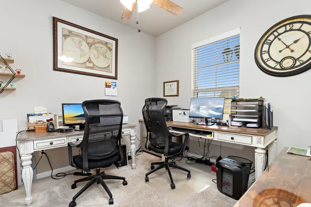 a view of a workspace with furniture and a window