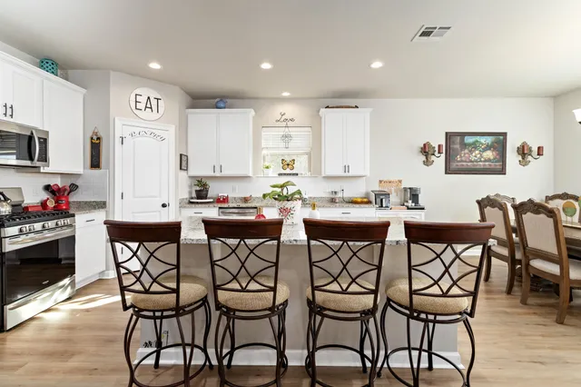 a view of a dining room with furniture and wooden floor