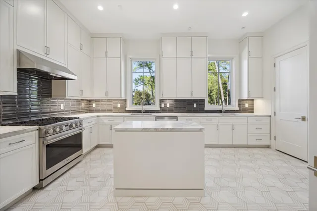 a kitchen with granite countertop white cabinets white stainless steel appliances with a sink and dishwasher