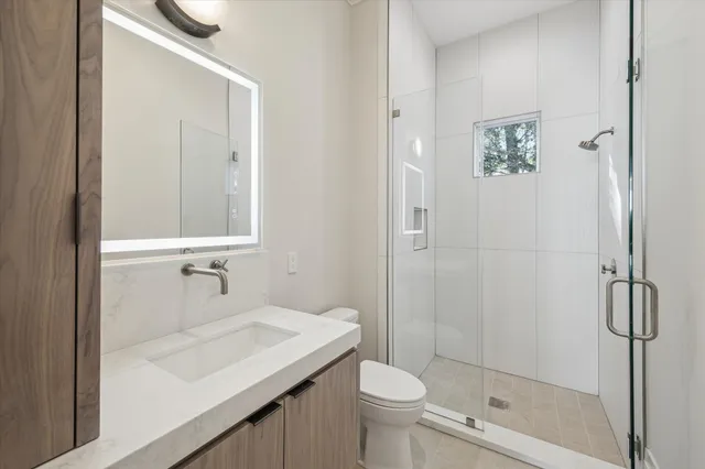 a bathroom with a sink toilet and shower