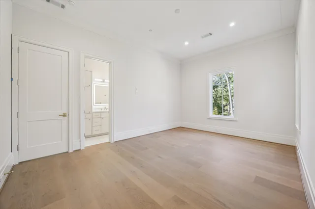 an empty room with windows and closet
