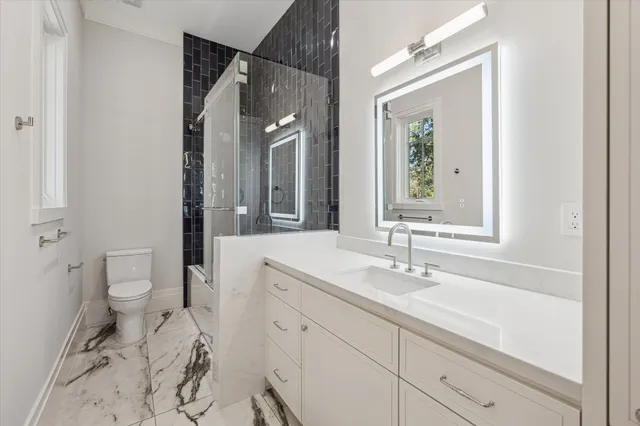 a bathroom with a sink toilet and shower
