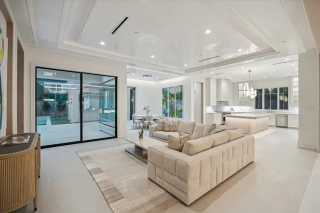 a living room with furniture and a glass door