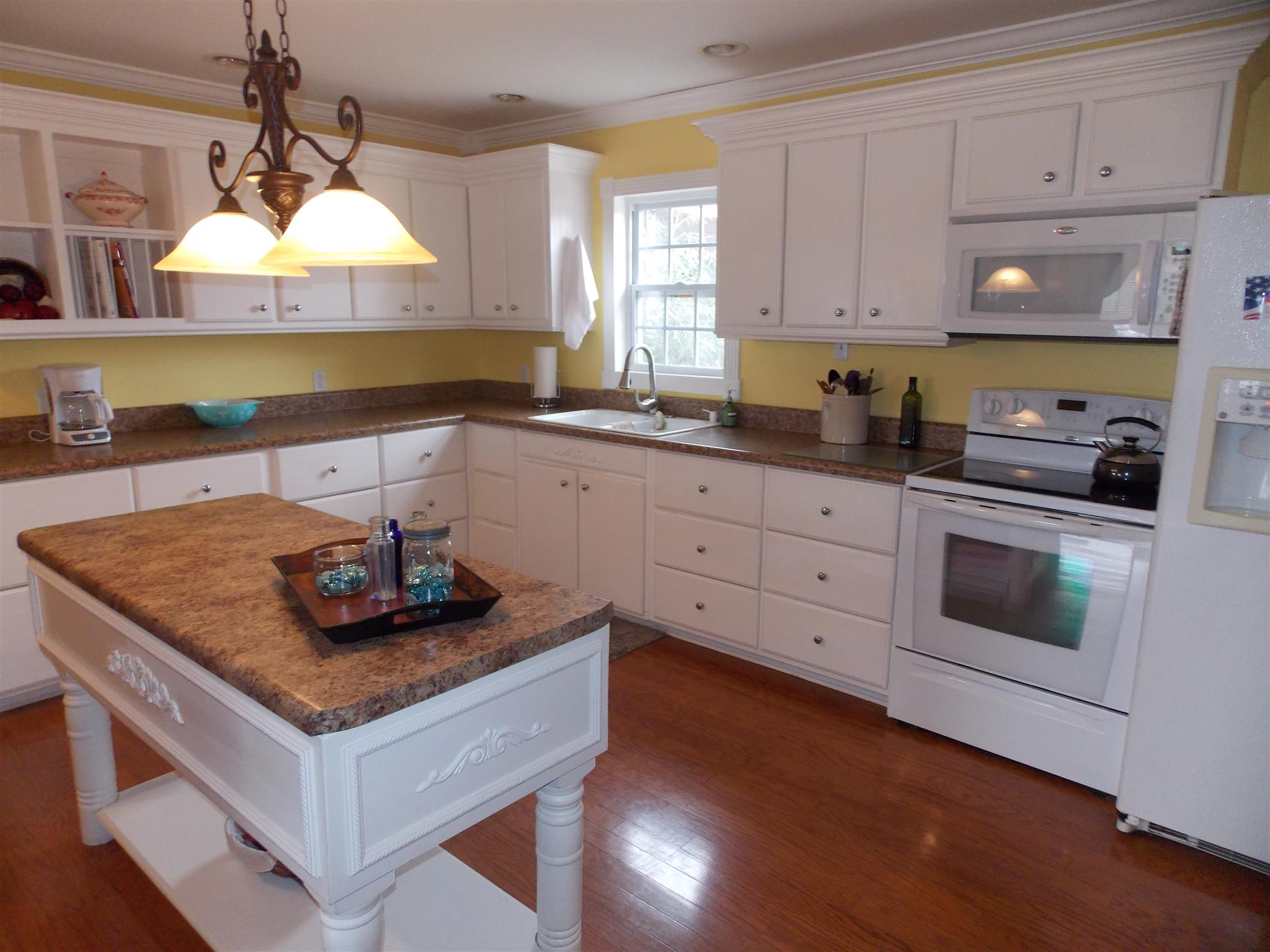 4364 Beasleys Bend Road Lebanon, TN 37087 - Photo 14 of 20 a kitchen with stainless steel appliances granite countertop a sink dishwasher stove and white cabinets with wooden floor