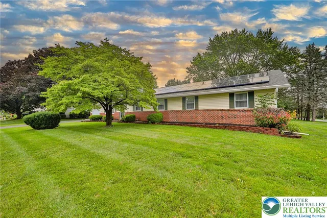 a view of house with outdoor space and garden