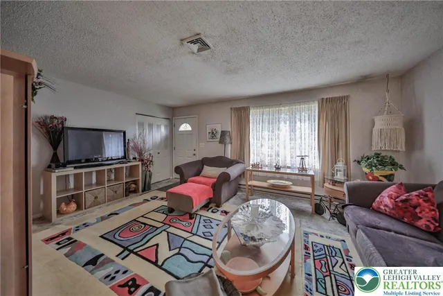 a kitchen with stainless steel appliances granite countertop a refrigerator a stove and a sink