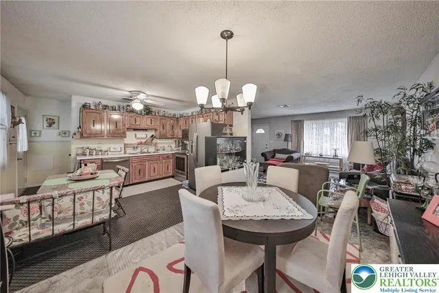 a living room with furniture a rug and a lamp