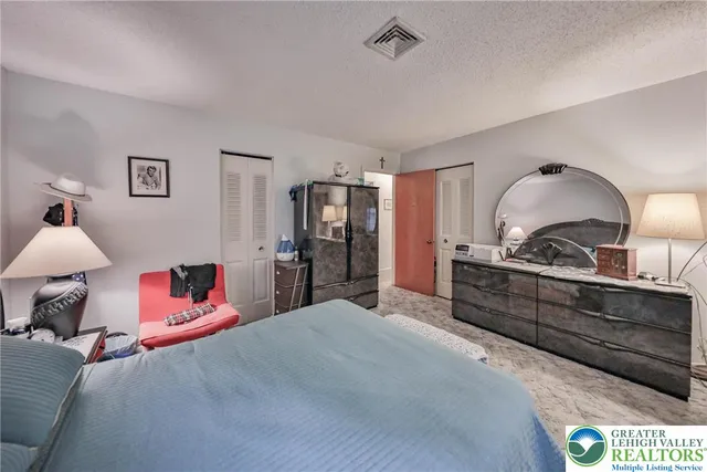 a bedroom with a bed and dresser