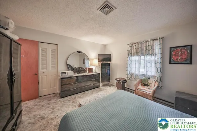 a view of a bedroom with workspace and bedroom