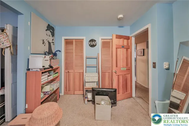 a view of a hallway with wooden shelves
