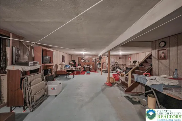 a living room with furniture cabinets and a flat screen tv