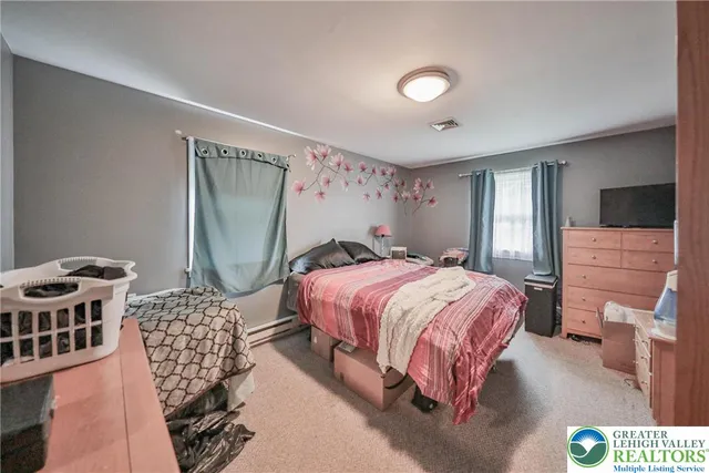 a kitchen with stainless steel appliances a refrigerator a sink dishwasher a stove and white cabinets