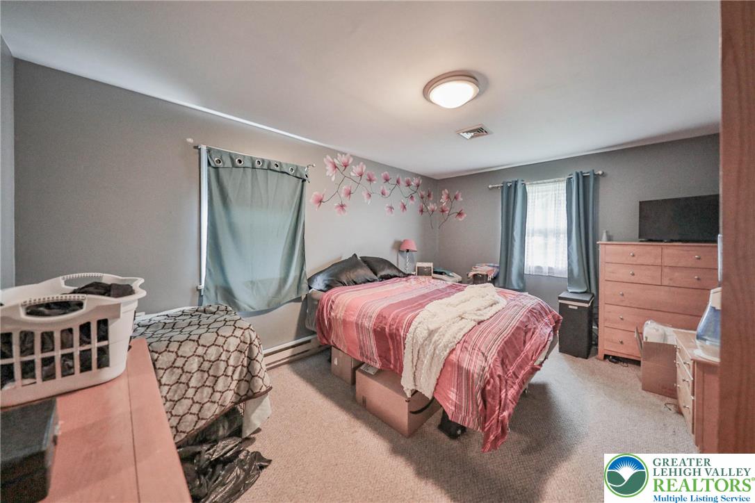 1502 2nd Street Bethlehem, PA 18020 - Photo 37 of 62 a spacious bedroom with a bed and a mirror