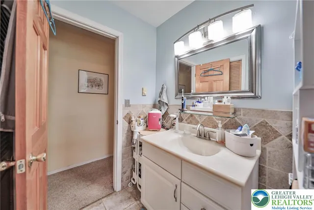 a living room with lots of furniture and kitchen view