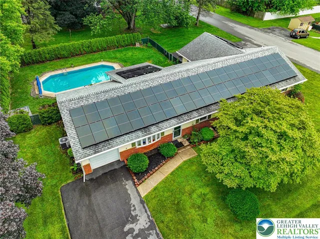 a view of a house with swimming pool and yard
