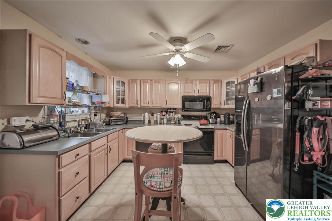 1502 2nd Street Bethlehem, PA 18020 - Photo 44 of 62 a kitchen with stainless steel appliances a refrigerator a sink dishwasher a stove and white cabinets