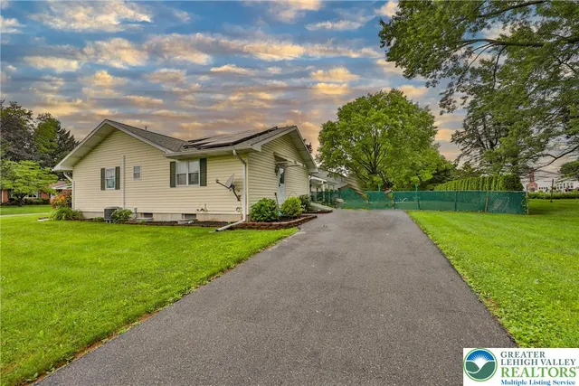 a view of a chairs and table in backyard of the house