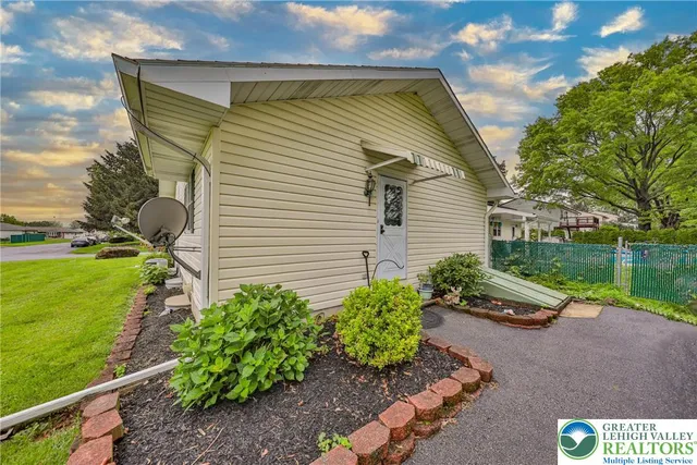 a view of green field with house in the background