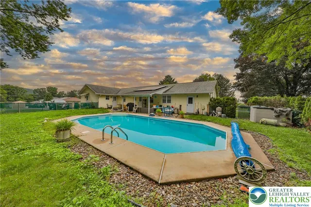 a front view of house with yard outdoor seating and barbeque oven