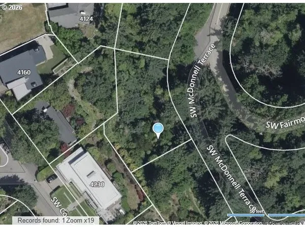 an aerial view of residential houses with outdoor space and street view