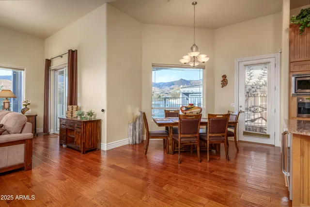 a kitchen with stainless steel appliances granite countertop a stove top oven a sink dishwasher and cabinets with wooden floor