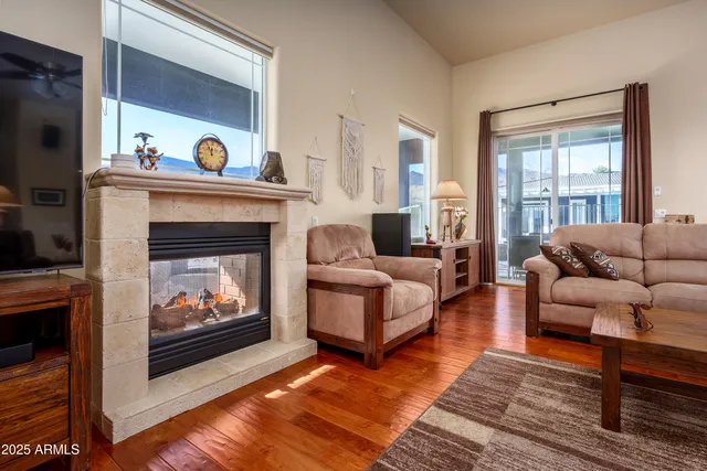 a living room with furniture and a table with wooden floor