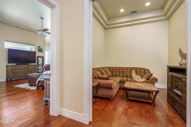 a spacious bedroom with a bed and a flat screen tv