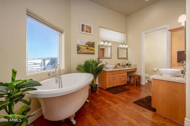 a bathroom with a granite countertop double vanity sink and a mirror