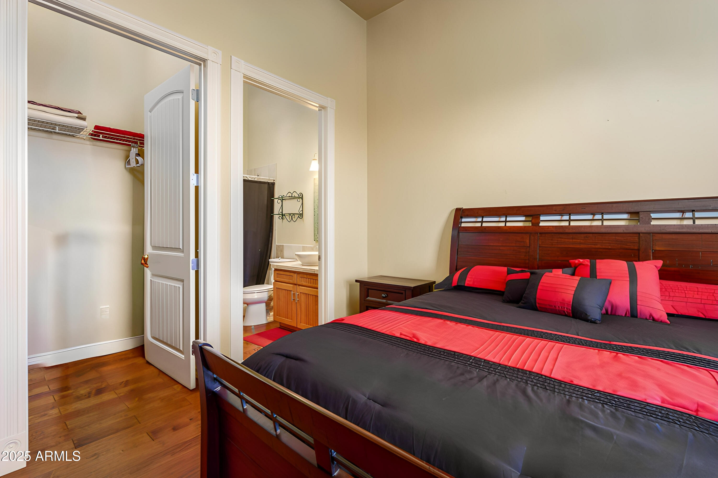 600 North Turquoise Way Clarkdale, AZ 86324 - Photo 26 of 51 a bedroom with a bed and wooden floor