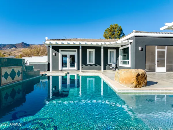 a view of a house with swimming pool and porch