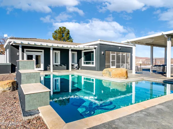 a front view of a house with swimming pool yard and outdoor seating