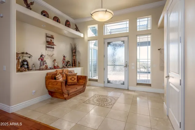 a dining room with wooden floor a chandelier a wooden table and chairs